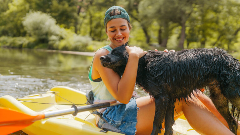 a woman kayaking with her dog