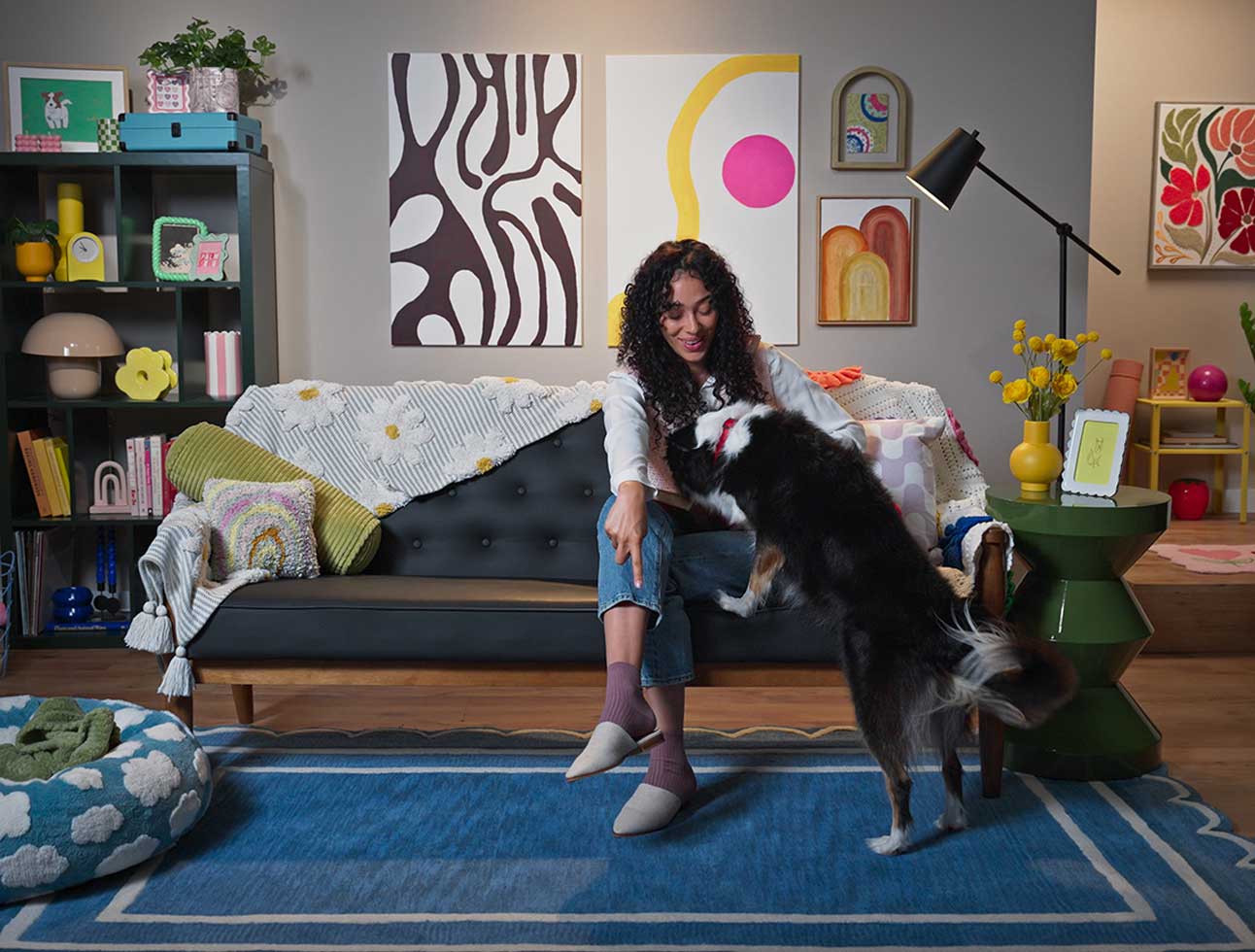A woman telling her dog to get down from the couch